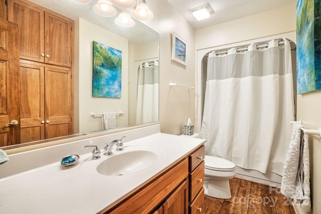 60 Laurel Ln, Mars Hill, NC 28754 - full bathroom featuring wood finished floors, toilet, vanity, and shower / bath combo with shower curtain