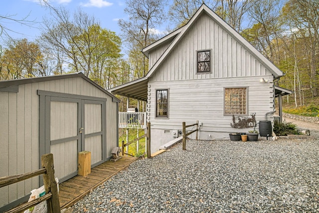 60 Laurel Ln, Mars Hill, NC 28754 - view of side of home with a storage unit, an outdoor structure, and board and batten siding