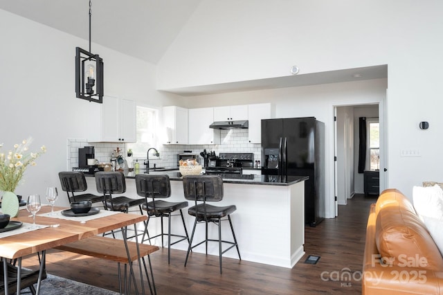 25 Licklog Ridge Rd, Fairview, NC 28730 - kitchen with black appliances, dark countertops, backsplash, a sink, and white cabinetry