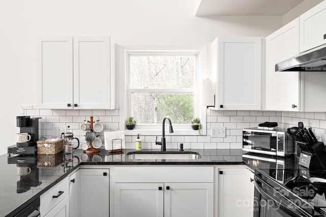 25 Licklog Ridge Rd, Fairview, NC 28730 - kitchen featuring a sink, stainless steel microwave, white cabinets, backsplash, and dark stone countertops