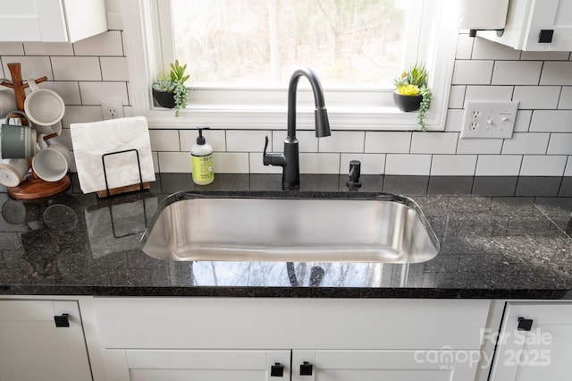 25 Licklog Ridge Rd, Fairview, NC 28730 - kitchen view of a sink, backsplash, white cabinetry, and dark stone countertops