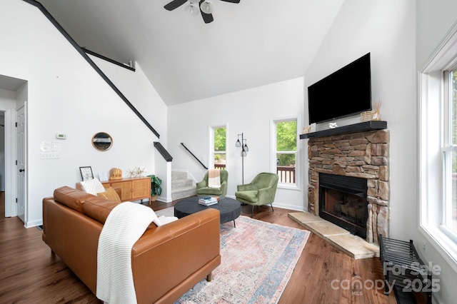 25 Licklog Ridge Rd, Fairview, NC 28730 - living room with high vaulted ceiling, stairs, a stone fireplace, ceiling fan, and wood finished floors