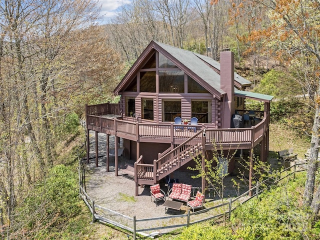16 Sutton Knob Rd, Maggie Valley, NC 28751 - back of house with a wooden deck, a chimney, a view of trees, and stairway