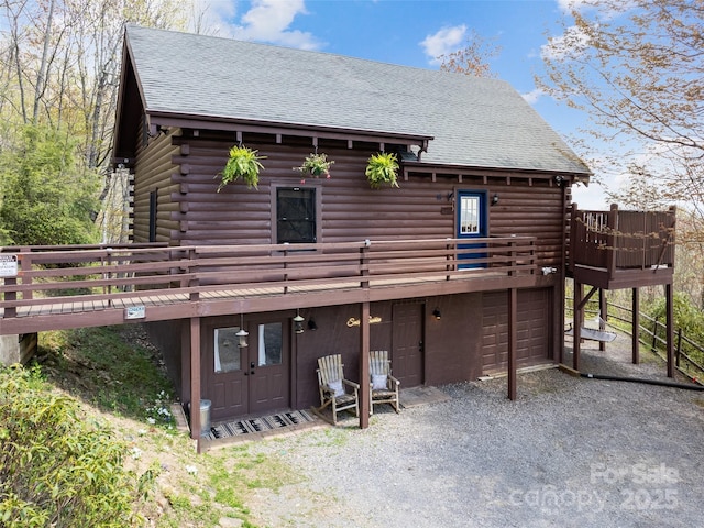 16 Sutton Knob Rd, Maggie Valley, NC 28751 - back of property with log siding, driveway, a wooden deck, and a shingled roof