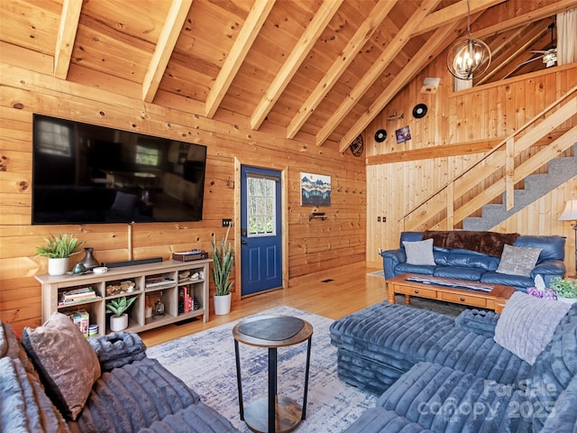 16 Sutton Knob Rd, Maggie Valley, NC 28751 - living room featuring wood walls, stairway, a chandelier, wood finished floors, and beamed ceiling