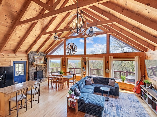16 Sutton Knob Rd, Maggie Valley, NC 28751 - living area featuring a ceiling fan, wooden ceiling, light wood-style flooring, wooden walls, and beamed ceiling