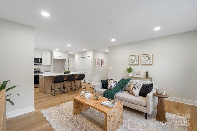 4042 Uppergate Ln, Charlotte, NC 28215 - living room with baseboards, light wood-type flooring, and recessed lighting