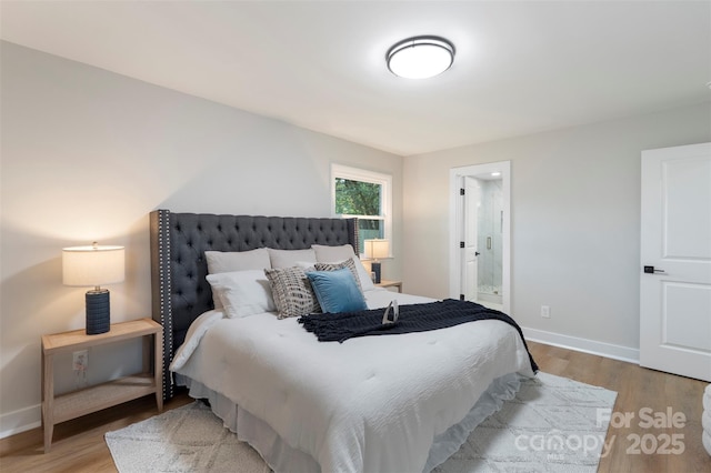 4042 Uppergate Ln, Charlotte, NC 28215 - bedroom featuring wood finished floors, baseboards, and ensuite bathroom