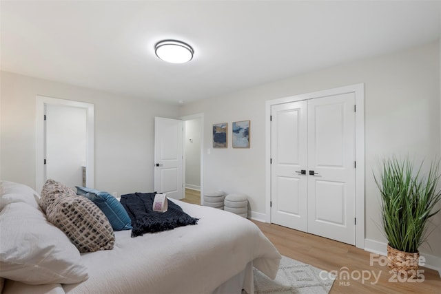 4042 Uppergate Ln, Charlotte, NC 28215 - bedroom with light wood finished floors, baseboards, and a closet