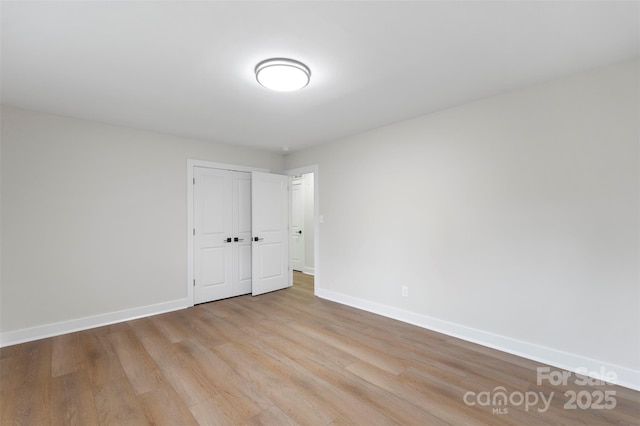 4042 Uppergate Ln, Charlotte, NC 28215 - unfurnished bedroom featuring wood finished floors, baseboards, and a closet