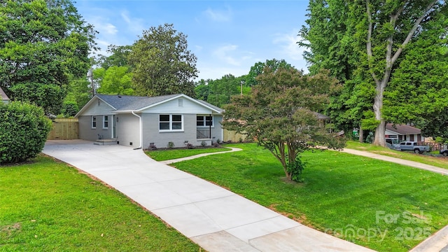 4042 Uppergate Ln, Charlotte, NC 28215 - single story home with concrete driveway, brick siding, and view of scattered trees