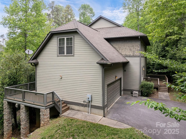 4 Yellow Owl Ct, Biltmore Lake, NC 28715 - view of side of home featuring a wooden deck, a shingled roof, driveway, and a garage
