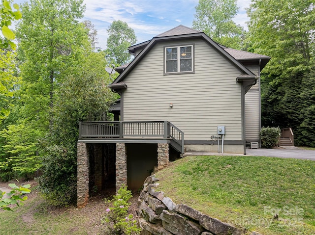 4 Yellow Owl Ct, Biltmore Lake, NC 28715 - view of property exterior featuring a wooden deck, a lawn, and a patio area