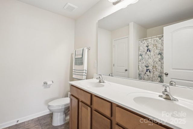 full bath with baseboards, toilet, double vanity, and tile patterned flooring