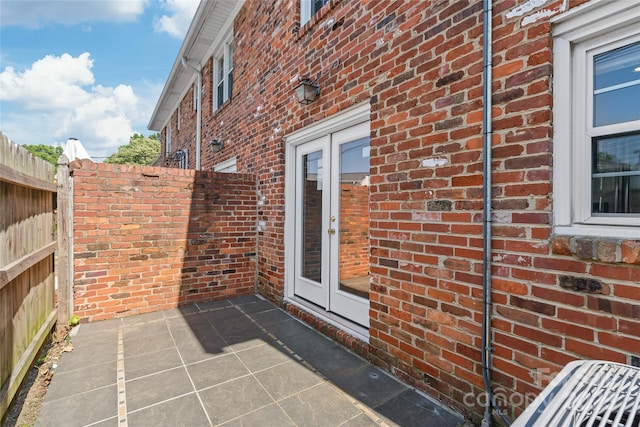 view of patio featuring fence and french doors