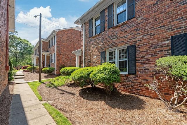 view of property exterior featuring brick siding