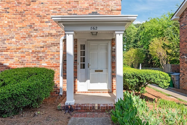 doorway to property with brick siding