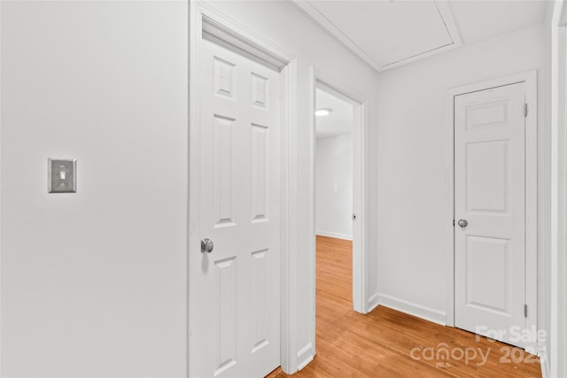 hallway with light wood-style flooring and baseboards