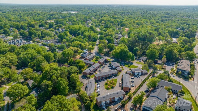 aerial overview of property's location with a heavily wooded area