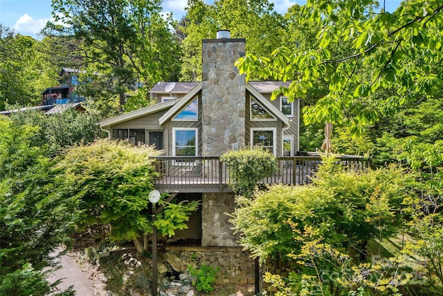 1795 Mckenzie Way N Unit 505, Old Fort, NC 28762 - rear view of house with a deck, a chimney, stone siding, and a sunroom