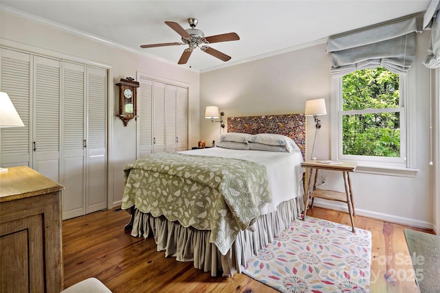 1795 Mckenzie Way N Unit 505, Old Fort, NC 28762 - bedroom with two closets, hardwood / wood-style flooring, crown molding, baseboards, and ceiling fan