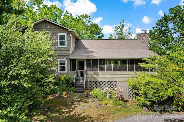 1795 Mckenzie Way N Unit 505, Old Fort, NC 28762 - view of front of home with a sunroom, a chimney, and roof with shingles