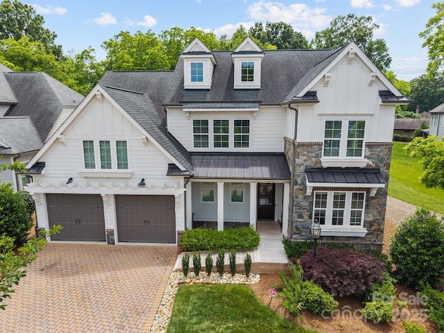 1012 N Sharon Amity Rd, Charlotte, NC 28211 - view of front of property featuring board and batten siding, stone siding, an attached garage, and decorative driveway