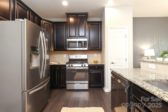 1809 Evergreen Dr, Charlotte, NC 28208 - kitchen with stainless steel appliances, recessed lighting, light stone counters, tasteful backsplash, and dark wood finished floors
