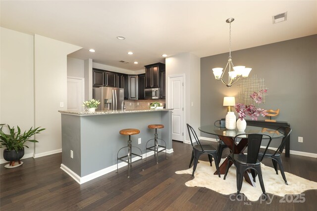 1809 Evergreen Dr, Charlotte, NC 28208 - dining space featuring a chandelier, dark wood-type flooring, recessed lighting, and baseboards