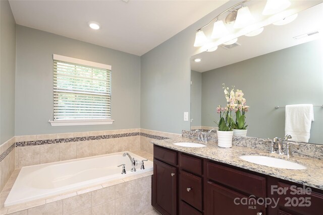 1809 Evergreen Dr, Charlotte, NC 28208 - bathroom featuring a garden tub and double vanity