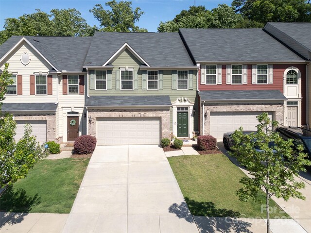 1809 Evergreen Dr, Charlotte, NC 28208 - multi unit property featuring a garage, driveway, a front lawn, and brick siding