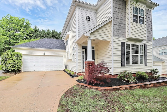 view of front of property featuring concrete driveway and a garage