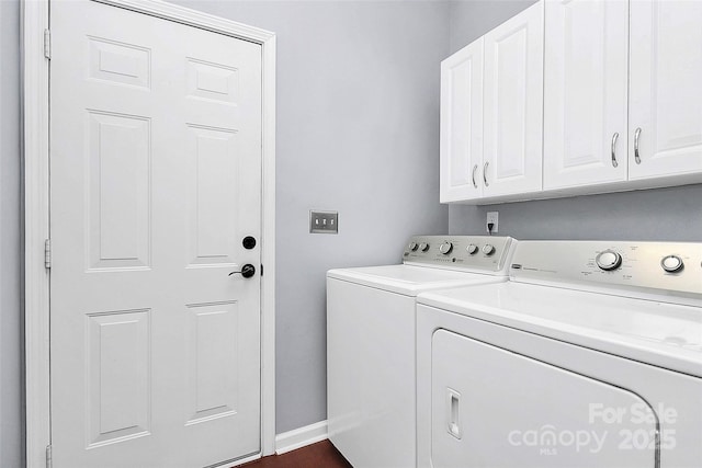 laundry room with washing machine and clothes dryer, cabinet space, and baseboards