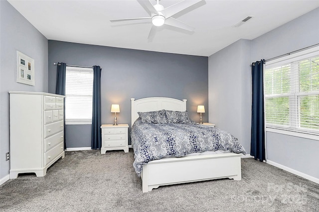 carpeted bedroom with multiple windows and baseboards