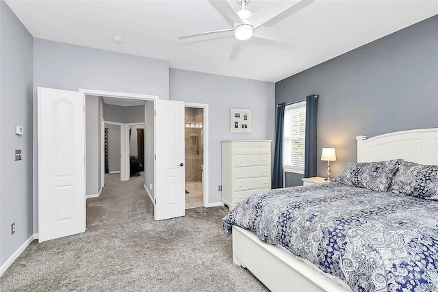 bedroom featuring carpet floors, baseboards, a ceiling fan, and ensuite bath