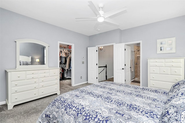 bedroom featuring a walk in closet, carpet, baseboards, and a closet