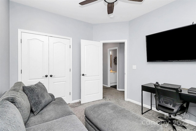 office space featuring carpet, a ceiling fan, and baseboards