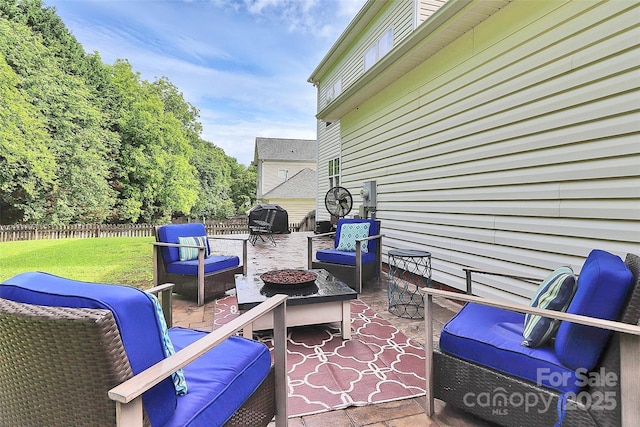 view of patio / terrace featuring an outdoor living space with a fire pit
