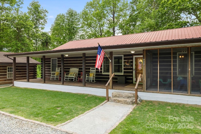 909 Pearson Falls Rd, Saluda, NC 28773 - back of property featuring metal roof, a porch, and a lawn