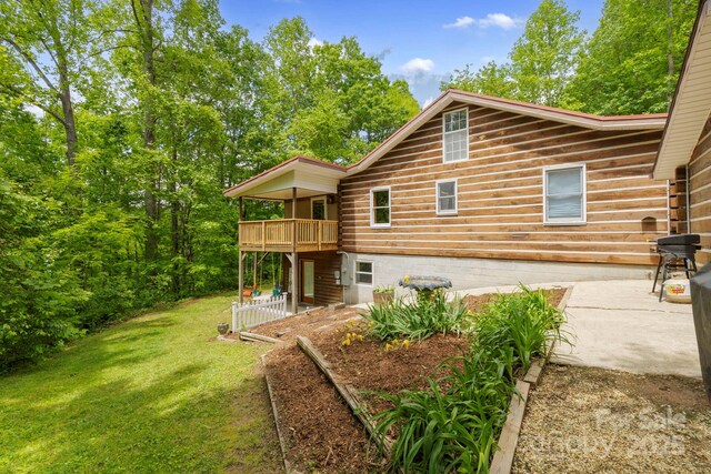 909 Pearson Falls Rd, Saluda, NC 28773 - rear view of property featuring a lawn, a patio, and a wooden deck