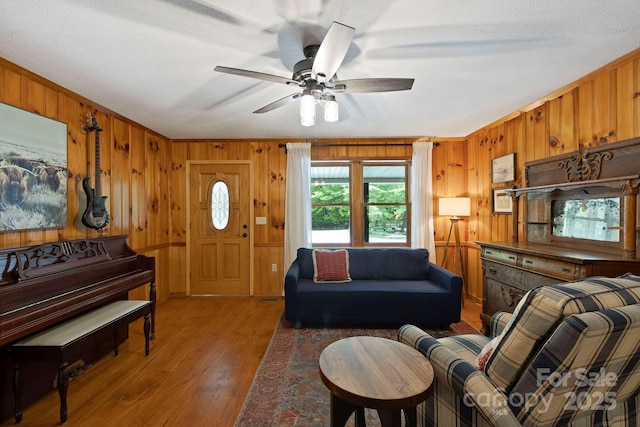 909 Pearson Falls Rd, Saluda, NC 28773 - living room featuring wood walls, wood finished floors, and ceiling fan