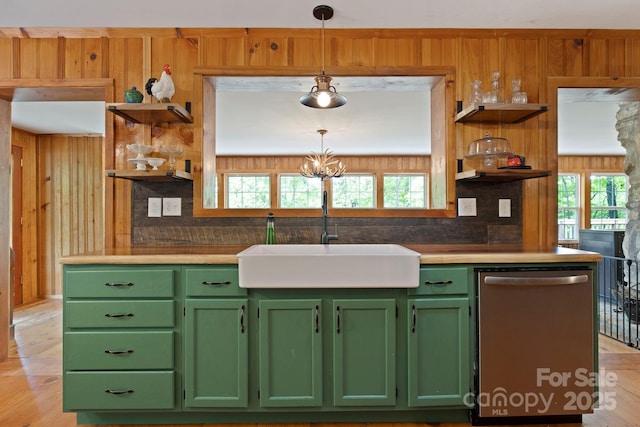 909 Pearson Falls Rd, Saluda, NC 28773 - kitchen featuring open shelves, stainless steel dishwasher, green cabinets, a sink, and wood walls