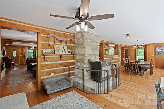 909 Pearson Falls Rd, Saluda, NC 28773 - living area with wooden walls, a ceiling fan, hardwood / wood-style floors, and a chandelier