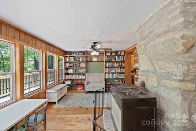 909 Pearson Falls Rd, Saluda, NC 28773 - sitting room featuring hardwood / wood-style floors, healthy amount of natural light, a ceiling fan, and wooden walls