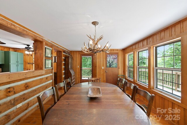 909 Pearson Falls Rd, Saluda, NC 28773 - dining room with wood walls and a chandelier