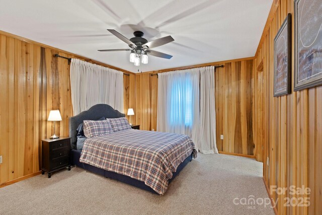 909 Pearson Falls Rd, Saluda, NC 28773 - bedroom featuring light carpet, wood walls, a ceiling fan, and baseboards