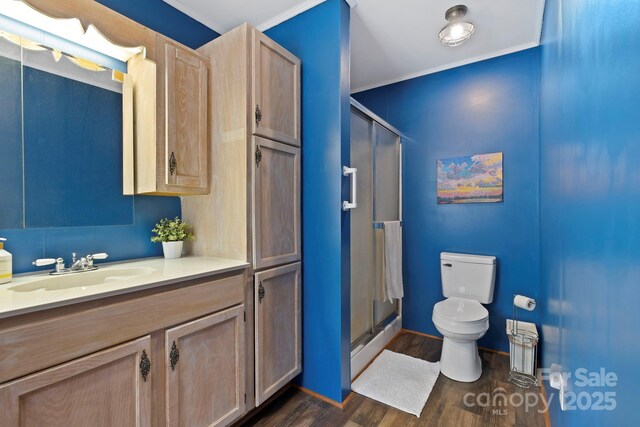 909 Pearson Falls Rd, Saluda, NC 28773 - full bathroom featuring toilet, a shower stall, wood finished floors, vanity, and crown molding