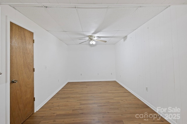 909 Pearson Falls Rd, Saluda, NC 28773 - unfurnished room with a ceiling fan, wood finished floors, a drop ceiling, and baseboards