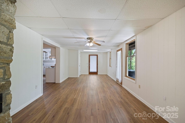 909 Pearson Falls Rd, Saluda, NC 28773 - unfurnished living room with wood finished floors, a ceiling fan, a drop ceiling, and baseboards