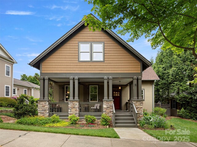 9 Dearborn St, Asheville, NC 28803 - view of front of house featuring covered porch, stone siding, and stucco siding